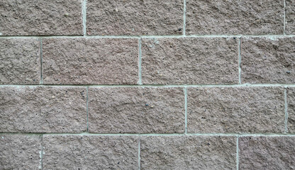 A wall of gray blocks. Background from large bricks