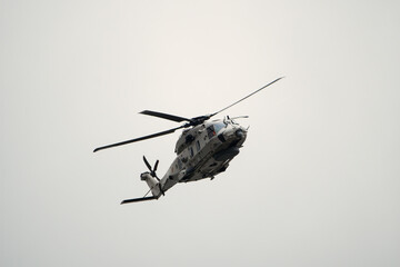 Sea military helicopter (airforce) in flight at Koksijde on a rainy and cloudy day ready for combat © LDC