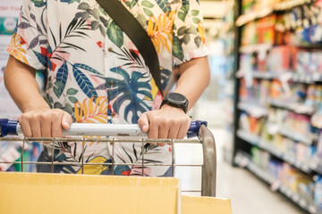 Handsome asian man shopping in a supermarket. shopping concept