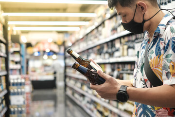 Handsome asian man shopping in a supermarket. shopping concept