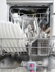Wine glass in dishwasher machine and  dishwasher detergent tablet