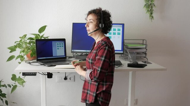 Woman telecommuting at an adjustable standing desk
