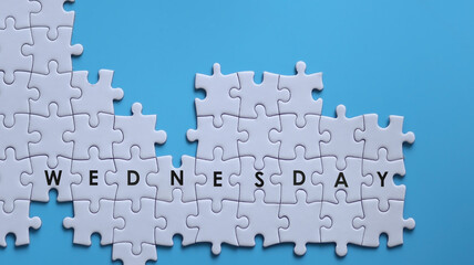 WEDNESDAY word written on white jigsaw puzzle