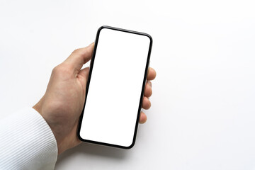 man’s hand holding and showing smartphone with blank white screen, Mockup image. Modern phone with blank screen.