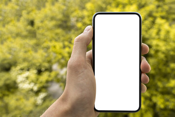 Fototapeta na wymiar man’s hand holding and showing smartphone with blank white screen, Mockup image. Modern phone with blank screen.