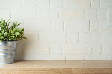 Empty wooden shelf with plant over brick wall interior. Kitchen mock up for design