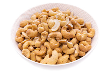 lightly roasted cashew nuts in a white bowl close-up.isolated food products