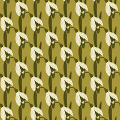 Vintage seamless pattern with doodle white spring snowdrops shapes. Green olive backdrop.
