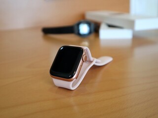 pink smart watch on the table