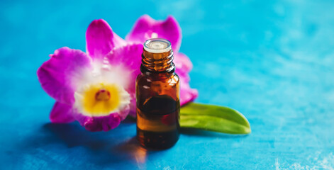 Flowers and plant extracts in small bottles. Selective focus.