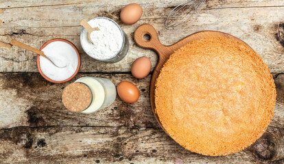 Homemade sponge cake with ingredients on a white wooden table. Bakery background concept. banner, menu recipe place for text