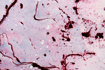 Abstract colorful red oil ink on paper close-up background texture