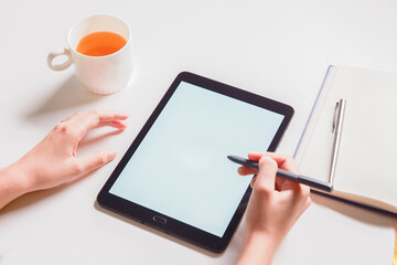 hand use tablet on white table workspace for write text or copy space.