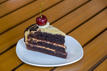 Slice of chocolate cheese cake on white plate