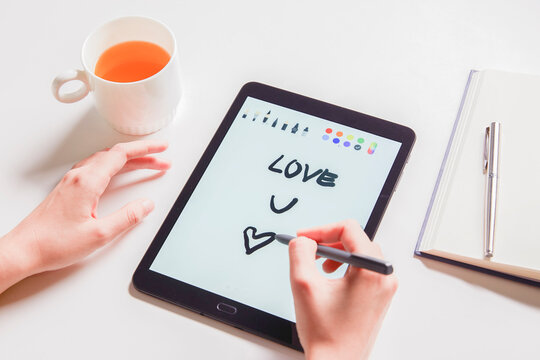 hand use tablet on white table workspace wite text Love you concept or valantine concept