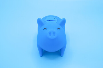 Piggy bank on blue background. Finance, saving money concept.