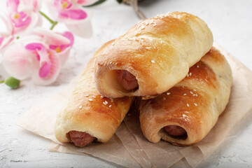 Sausage in the dough baked in the oven. Classic baked sausage in the dough.