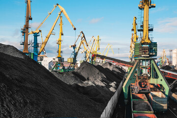 Mountains of coal on the territory of the Murmansk Commercial Sea Port. The unloading of wagons...