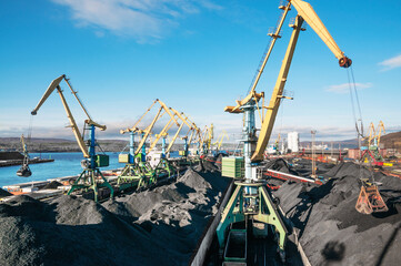 Industrial ship, Portal cranes. Loading coal into the holds of the ship in the seaport