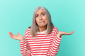 middle age white hair woman feeling puzzled and confused and doubting