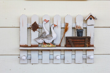 Two duck and white fence