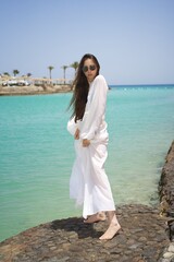 beautiful girl on the beach, on the sea, posing on the beach, rest on the sea. High quality photo