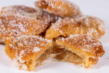 Fried sweet (borrachuelo) stuffed with angel hair, a typical Spanish dessert from Andalusia. Ideal for Christmas and Easter. Horizontal shot and selective focus.