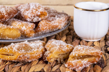 Fried sweet (borrachuelo) stuffed with angel hair, a typical Spanish dessert from Andalusia. Ideal for Christmas and Easter. Horizontal shot and selective focus.