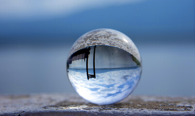 Scenery blue sky view through a glass ball, crystal ball.