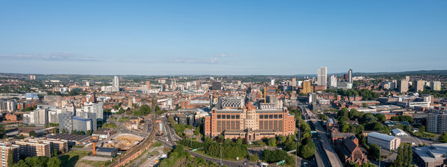 Aerial View of Leeds city centre on a sunny day showing large council office buildings and surrounding retail stores, offices and apartments. 