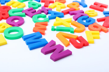 Fototapeta premium Many colorful magnetic letters on white background