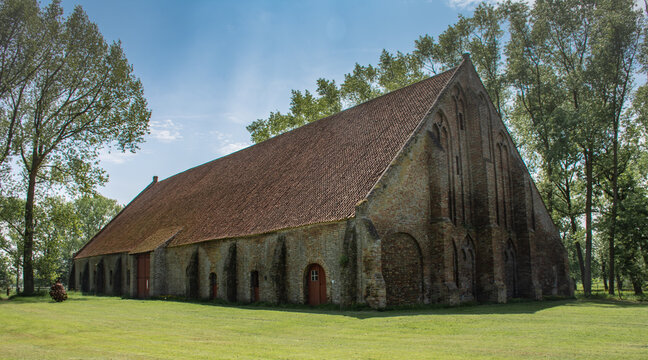 
medieval tithe barn with huge roof of the abbey 'Ter Doest' in Lissewege near Bruges, Belgium