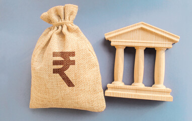 Indian rupee money bag and government building. Business and finance concept. Deposit, loan and...