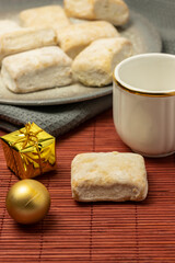 Typical Christmas sweet (Hojaldrina) similar to polvorón and mantecado, made with layers of puff pastry inside. Vertical shot and selective focus