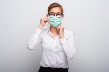 Portrait of Asian teenager in medical face mask to protect Covid-19 (Coronavirus) Casual Asian Casual Asian woman wearing white shirt over white background.