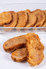 Fried bread with milk, egg, sugar and cinnamon (Torrijas). Typical Spanish Easter sweet. Vertical photography and selective focus