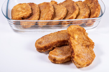 Fried bread with milk, egg, sugar and cinnamon (Torrijas). Typical Spanish Easter sweet. Horizontal photography and selective focus