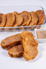 Fried bread with milk, egg, sugar and cinnamon (Torrijas). Typical Spanish Easter sweet. Vertical photography and selective focus
