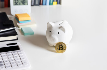 Crypto currency,bitcoin with piggy bank on desk.