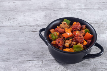 Extremadura crumbs, breadcrumbs, sausage, bacon, red and green peppers, garlic and paprika. Concept of traditional home cooking. Horizontal photo and selective focus