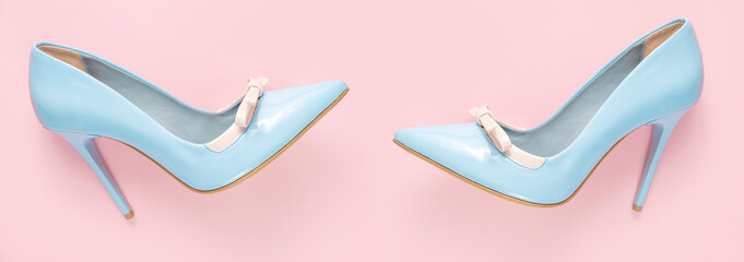 Pare of  blue shiny high heel shoes on pink background, flat lay, banner