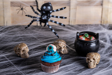 halloween cupcake, chocolate, blue and black battercream and gumdrop eyes. Horizontal shot and selective focus