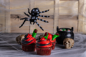 halloween cupcake, chocolate, blue and black battercream and gumdrop fingers. Horizontal shot and selective focus