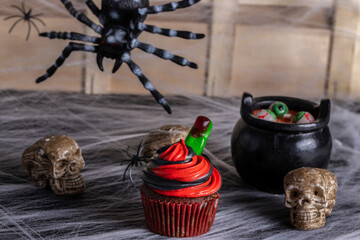 halloween cupcake, chocolate, blue and black battercream and gumdrop fingers. Horizontal shot and selective focus