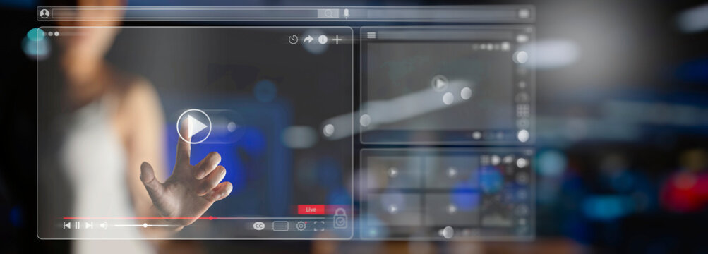 Video streaming on internet Concept.Businesswoman watching online movie or TV series on modern computer virtual screen with multimedia player with play button icon.