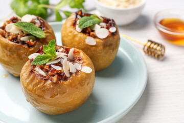 Baked apples on white wooden table, closeup