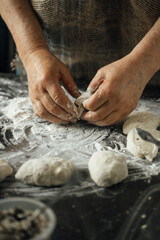 close-up view of hands making delicious pies with dough