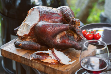 Festive table in the garden with grilled whole turkey - obrazy, fototapety, plakaty