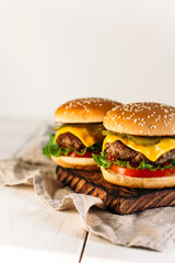 two burgers on a wooden background 