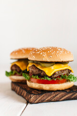two burgers on a wooden background 